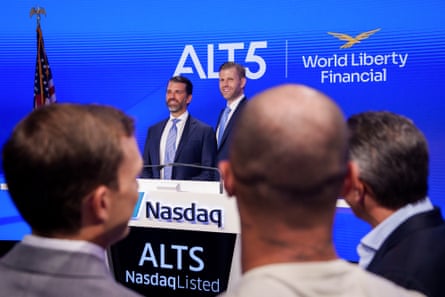 Two men side by side  in front of a Nasdaq podium