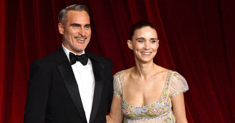 Joaquin Phoenix Fixes Rooney Mara’s Train at Academy Gala
