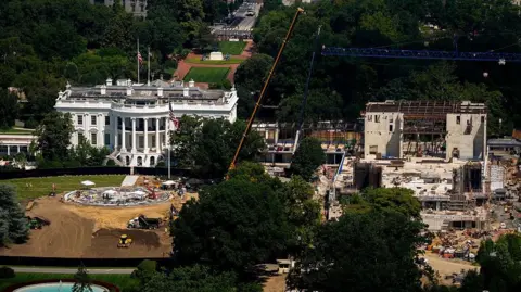 Getty Images Construction continues on a new helipad on the South Lawn of the White House and the East Wing ballroom on 24 August 2026 in Washington DC.