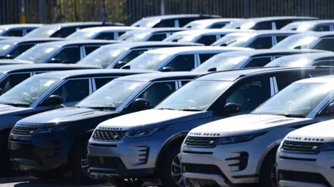 Getty Images Rows of black and silver Land Rover cars