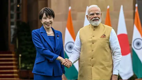 Bloomberg via Getty Images Japan's Sanae Takaichi and India's Narendra Modi shake hands at Hyderabad House in New Delhi, India on 2 July 2026