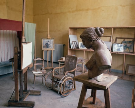Renoir’s studio with a sculpted bust, wheelchair, easels and paintings on display