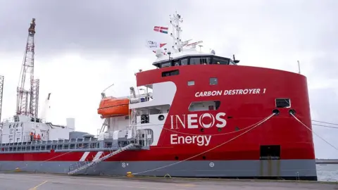 AFP via Getty Images A carbon dioxide carrier vessel naed Carbon Destroyer 1 in dock. It also bears the brand name Ineos