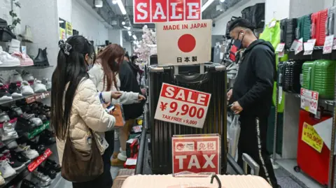 Anadolu via Getty Images The interior of a retail store known for its dense 'jungle-like' displays and competitive pricing on items like luggage and shoes, seen with interior 'sale' signs, in central Osaka, Japan, on 1 April, 2026.