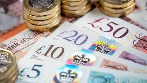 Getty Images Pound coins and a 5,10,20 and 50 pound note