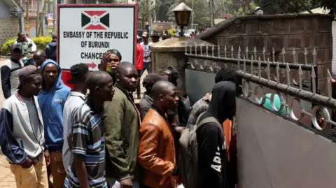 Reuters Line of people outside the embassy. there is a sign that reads Embassy of the Republic of Burundi
