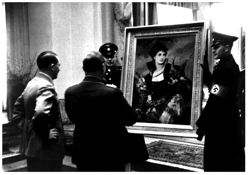 Adolf Hitler presents Hermann Goering with "The Falconer" (1880), a painting by Hans Makart, in a film still from "The Rape of Europa"