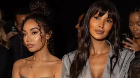 Daniele Venturelli/WireImage Leigh-Anne Pinnock and Maya Jama on the front row during Milan Fashion Week in 2024