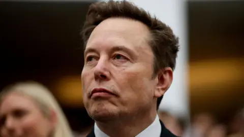 Reuters Elon Musk seated during a recent event at the White House.