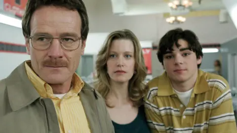 Alamy A still from Breaking Bad showing RJ Mitte as Walter White Jr. (right) alongside Bryan Cranston and Anna Gunn in series one of Breaking Bad in 2008