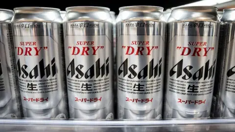 AFP via Getty Images Asahi Super Dry beers are seen on display at a supermarket in Tokyo on October 3, 2025.