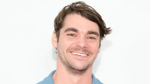 Getty Images RJ Mitte smiling and wearing a light blue top
