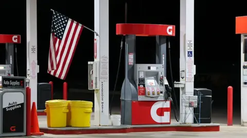 LightRocket via Getty Images An American flag is displayed at a gas pump at a Giant grocery store.